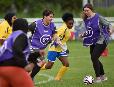 Women councillors, leaders and refugees playing football