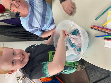A child mixes dough in a bowl