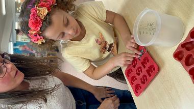 A child making a biodegradable keyring at a HAF session at Chester Lane Library